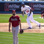 Los Angeles Dodgers' Yasiel Puig, right, hits a three-run home run as Arizona Diamondbacks relief pitcher Josh Collmenter watches the ball during the sixth inning of a baseball game, Sunday, April 20, 2014, in Los Angeles. (AP Photo/Mark J. Terrill)