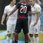 Germany's Jerome Boateng, center, argues with United States' Clint Dempsey, right, as United States' Omar Gonzalez looks on during the group G World Cup soccer match between the USA and Germany at the Arena Pernambuco in Recife, Brazil, Thursday, June 26, 2014. (AP Photo/Matthias Schrader)
