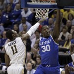 Kentucky's Julius Randle, right, heads to the basket as Wichita State's Cleanthony Early defends during the first half of a third-round game of the NCAA college basketball tournament Sunday, March 23, 2014, in St. Louis. (AP Photo/Jeff Roberson)
