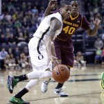 Oregon guard Joseph Young, left, drives to the basket past Arizona State forward Shaquielle McKissic during the first half of an NCAA college basketball game in Eugene, Ore., Tuesday, March 4, 2014. (AP Photo/Don Ryan)