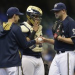 Milwaukee Brewers starting pitcher Tyler Wagner, right, is removed by manager Craig Counsell, left, as catcher Martin Maldonado, center, looks on during the fourth inning of a baseball game against the Arizona Diamondbacks, Sunday, May 31, 2015, in Milwaukee. (AP Photo/Jeffrey Phelps)
