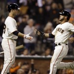 San Francisco Giants' Gregor Blanco, right, is congratulated by Buster Posey after Blanco scored in the sixth inning of a baseball game against the Arizona Diamondbacks on Tuesday, Sept. 9, 2014, in San Francisco. (AP Photo/Ben Margot)