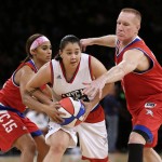 Skylar Diggins, left, and Chris Mullin, right, defend Shoni Schimmel, center, during the second half of the NBA All-Star celebrity basketball game Friday, Feb. 13, 2015, in New York. (AP Photo/Frank Franklin II)