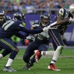 New England Patriots wide receiver Brandon LaFell (19), right, breaks away from Seattle Seahawks cornerback Byron Maxwell (41), left, as middle linebacker Bobby Wagner (54) tries to tackle him during the first half of NFL Super Bowl XLIX football game Sunday, Feb. 1, 2015, in Glendale, Ariz. (AP Photo/Mark Humphrey)