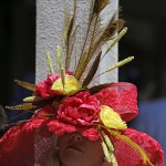 A woman wears a hat before the 141st running of the Kentucky Oaks horse race at Churchill Downs Friday, May 1, 2015, in Louisville, Ky. (AP Photo/Jeff Roberson)