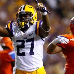 LSU running back Kenny Hilliard (27) celebrates past Sam Houston State defensive tackle Sione Latu (96) after scoring a 2-point conversion during the first half of an NCAA college football game in Baton Rouge, La., Saturday, Sept. 6, 2014. (AP Photo/Jonathan Bachman)