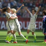 United States' Lauren Holiday, left, Megan Rapinoe (15) and Meghan Klingenberg (22) celebrate Holiday's goal as Japan's Shinobu Ohno, right, watches during first half FIFA Women's World Cup soccer championship in Vancouver, British Columbia, Canada, Sunday, July 5, 2015. (Darryl Dyck/The Canadian Press via AP) MANDATORY CREDIT
