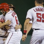  Washington Nationals' Kevin Frandsen, left, hugs teammate Anthony Rendon after Rendon hit the game-winning single in the ninth inning of a baseball game against the Arizona Diamondbacks on Wednesday, Aug. 20, 2014, in Washington. At right is Jose Lobaton. The Nationals won 3-2. (AP Photo/Evan Vucci)