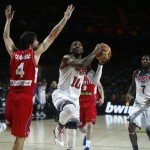 United States' Kyrie Irving, centre, jumps to push the ball up to the basket during the final World Basketball match between the United States and Serbia at the Palacio de los Deportes stadium in Madrid, Spain, Sunday, Sept. 14, 2014. (AP Photo/Andres Kudacki)