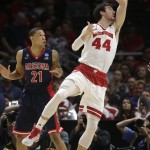 Wisconsin forward Frank Kaminsky (44) is fouled by Arizona forward Brandon Ashley (21) during the first half of a college basketball regional final in the NCAA Tournament, Saturday, March 28, 2015, in Los Angeles. (AP Photo/Jae C. Hong)