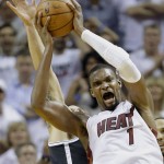 Miami Heat center Chris Bosh battles for a loose ball with Brooklyn Nets guard Deron Williams, rear, during the second half of Game 2 of an Eastern Conference semifinal basketball game, Thursday, May 8, 2014 in Miami. The Heat defeated the Nets 94-82. (AP Photo/Wilfredo Lee)