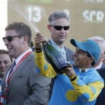 Victor Espinoza celebrates after riding American Pharoah to victory in the 141st running of the Kentucky Derby horse race at Churchill Downs Saturday, May 2, 2015, in Louisville, Ky. (AP Photo/Brynn Anderson)