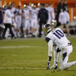 Washington quarterback Cyler Miles (10) watches after throwing an interception against Oklahoma State during the second half of the Cactus Bowl NCAA college football game, Friday, Jan. 2, 2015, in Tempe, Ariz. Oklahoma State won 30-22. (AP Photo/Matt York)