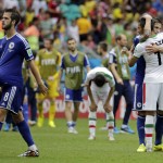  Iran's Reza Ghoochannejhad is consoled by Bosnia's Muhamed Besic, as Bosnia's Miralem Pjanic (8) walks off with the ball under his shirt after the group F World Cup soccer match between Bosnia and Iran at the Arena Fonte Nova in Salvador, Brazil, Wednesday, June 25, 2014. Bosnia won the match 3-1. (AP Photo/Fernando Llano)