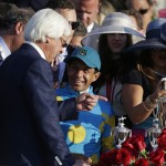 Victor Espinoza talks with Bob Baffert after Espinoza rode American Pharoah to victory in the 141st running of the Kentucky Derby horse race at Churchill Downs Saturday, May 2, 2015, in Louisville, Ky. (AP Photo/Brynn Anderson)