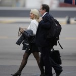 New England Patriots head coach Bill Belichick arrives with his partner Linda Holliday at Sky Harbor Airport for NFL Super Bowl XLIX football game against the Seattle Seahawks Monday, Jan. 26, 2015, in Phoenix. (AP Photo/David J. Phillip)
