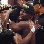 Floyd Mayweather Jr., center-right, hugs Manny Pacquiao, from the Philippines, after their welterweight title fight on Saturday, May 2, 2015 in Las Vegas. (AP Photo/Eric Jamison)