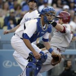  Arizona Diamondbacks' Paul Goldschmidt, right, slides to score on a double hit by Miguel Montero as Los Angeles Dodgers catcher Drew Butera, foreground, waits for the throw during the third inning of a baseball game on Saturday, April 19, 2014, in Los Angeles. (AP Photo/Jae C. Hong)