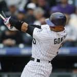 Colorado Rockies right fielder Carlos Gonzalez breaks his bat while flying out against the Arizona Diamondbacks to lead of the bottom of the seventh inning of the first game of a baseball doubleheader, Wednesday, May 6, 2015, in Denver. (AP Photo/David Zalubowski)