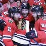 Chicago Blackhawks' Duncan Keith, left, is congratulated by teammates Brandon Saad and Patrick Kane, right, after scoring during the second period in Game 6 of the NHL hockey Stanley Cup Final series on against the Tampa Bay Lightning Monday, June 15, 2015, in Chicago. (AP Photo/Nam Y. Huh)