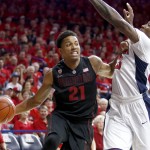 Stanford forward Anthony Brown (21) drives on Arizona forward Rondae Hollis-Jefferson during the first half of an NCAA college basketball game, Saturday, March 7, 2015, in Tucson, Ariz. (AP Photo/Rick Scuteri)