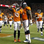 Denver Broncos wide receiver Emmanuel Sanders (10) salutes after scoring his third touchdown of the night, as teammate Orlando Franklin (74) joins him during the second half of an NFL football game against the San Diego Chargers, Thursday, Oct. 23, 2014, in Denver. (AP Photo/Jack Dempsey)
