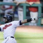  Cleveland Indians' Carlos Santana hits a double off Arizona Diamondbacks starting pitcher Vidal Nuno in the sixth inning of the first baseball game of a doubleheader, Wednesday, Aug. 13, 2014, in Cleveland. (AP Photo/Tony Dejak)