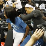 Minnesota Lynx forward Maya Moore signs Little League World Series pitcher Mo'Ne Davis' shirt prior to Game 2 of the WNBA basketball Western Conference finals against the Phoenix Mercury, Sunday, Aug. 31, 2014, in Minneapolis. (AP Photo/Stacy Bengs)