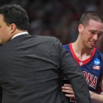 Arizona guard T.J. McConnell hugs head coach Sean Miller as McConnell leaves the game late in the second half of a college basketball regional final against Wisconsin in the NCAA Tournament, Saturday, March 28, 2015, in Los Angeles. Wisconsin beat Arizona 85-78 to advance to the Final Four. (AP Photo/Mark J. Terrill)