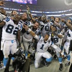 Carolina Panthers players including Cam Newton (1) celebrate in the final moments in the second half of an NFL wild card playoff football game against the Arizona Cardinals in Charlotte, N.C., Saturday, Jan. 3, 2015. (AP Photo/Chuck Burton)