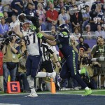 New England Patriots tight end Rob Gronkowski (87) catches a 22-yard touchdown pass against Seattle Seahawks outside linebacker K.J. Wright (50) during the first half of NFL Super Bowl XLIX football game Sunday, Feb. 1, 2015, in Glendale, Ariz. (AP Photo/Kathy Willens)