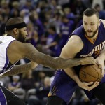 Sacramento Kings center DeMarcus Cousins, left, tries to steal the ball from Phoenix Suns center Miles Plumlee during the first quarter of an NBA basketball game in Sacramento, Calif., Sunday, Feb. 8, 2015. (AP Photo/Rich Pedroncelli)