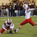 Utah's Andy Phillips, right, gets ready to attempt a field goal, which he misses, as teammate Tom Hackett (33) holds the ball in overtime of an NCAA college football game loss to Arizona State on Saturday, Nov. 1, 2014, in Tempe, Ariz. Arizona State defeated the Utah 19-16 in overtime. (AP Photo/Ross D. Franklin)