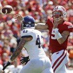 Wisconsin quarterback Tanner McEvoy throws past Western Illinois's J.J. Raffelson (43) during the second half of an NCAA college football game Saturday, Sept. 6, 2014, in Madison, Wis. Wisconsin won 37-3. (AP Photo/Morry Gash)