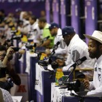 Seattle Seahawks' Michael Bennett, right, answers questions with teammates during media day for NFL Super Bowl XLIX football game Tuesday, Jan. 27, 2015, in Phoenix. (AP Photo/Charlie Riedel)
