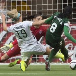 United States' Julie Johnston tries to stop Nigeria's Desire Oparanozie from getting a shot on goal keeper Hope Solo during the first half of a FIFA Women's World Cup soccer match, Tuesday, June 16, 2015 in Vancouver, New Brunswick, Canada (Jonathan Hayward/The Canadian Press via AP)