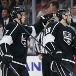 Los Angeles Kings defenseman Brayden McNabb, left, congratulates left wing Andy Andreoff, right, on his second period goal against the Arizona Coyotes during an NHL hockey game, Monday, March 16, 2015, in Los Angeles. (AP Photo/Danny Moloshok)