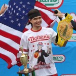 Matt Stonie poses for photographs after winning Nathan's Famous Fourth of July International Hot Dog Eating Contest men's competition, Saturday July 4, 2015 in the Coney Island section in the Brooklyn borough of New York. Stonie ate 62 hot dogs and buns in 10 minutes. (AP Photo/Tina Fineberg)
