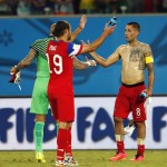 United States' Clint Dempsey (8) is congratulated by teammates Tim Howard and Graham Zusi (19) after the group G World Cup soccer match between Ghana and the United States at the Arena das Dunas in Natal, Brazil, Monday, June 16, 2014. (AP Photo/Julio Cortez)
