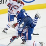 Toronto Maple Leafs' Joffrey Lupul, right, collides with Montreal Canadiens' Tom Gilbert as Canadiens' teammate Andrei Markov looks on during first period NHL hockey action in Toronto on Wednesday, Oct. 8, 2014. (AP Photo/The Canadian Press, Darren Calabrese)