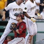 Pittsburgh Pirates' Gregory Polanco, right, and teammate Jordy Mercer, left, head to the dugout past Arizona Diamondbacks catcher Miguel Montero after Polanco's two-run home run off Arizona Diamondbacks starting pitcher Chase Anderson during the second inning of a baseball game in Pittsburgh Wednesday, July 2, 2014. (AP Photo/Gene J. Puskar)
