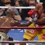 Floyd Mayweather Jr., left, hits Manny Pacquiao, from the Philippines, during their welterweight title fight on Saturday, May 2, 2015 in Las Vegas. (AP Photo/Eric Jamison)