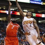 Phoenix Suns' Eric Bledsoe, right, blocks the shot of Houston Rockets' Patrick Beverley, left, during the first half of an NBA basketball game Tuesday, Feb. 10, 2015, in Phoenix. (AP Photo/Ross D. Franklin)