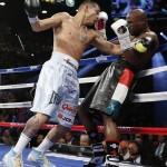 Marcos Maidana, left, from Argentina, drives Floyd Mayweather Jr. against the ropes in their WBC-WBA welterweight title boxing fight Saturday, May 3, 2014, in Las Vegas. (AP Photo/Eric Jamison)