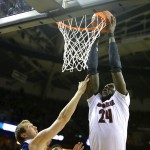 Louisville's Montrezl Harrell (24) dunks over UC Irvine's John Ryan, left, during the first half of an NCAA college tournament basketball game in the Round of 64 in Seattle, Friday, March 20, 2015. (AP Photo/Ted S. Warren)