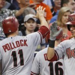 Arizona Diamondbacks' A.J. Pollock high-fives his way back to the dugout after scoring on a bases-loaded single to center by Paul Goldschmidt dyring the third inning of a baseball game Friday, June 26, 2015, in San Diego. (AP Photo/Lenny Ignelzi)
