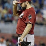 Arizona Diamondbacks starting pitcher Josh Collmenter adjusts his cap after giving up a three-run home run to Miami Marlins' Giancarlo Stanton in the first inning during a baseball game, Sunday, Aug.17, 2014, in Miami. (AP Photo/Lynne Sladky)
