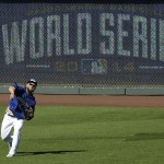 Kansas City Royals' Alex Gordon throws during baseball practice Monday, Oct. 20, 2014, in Kansas City, Mo. The Royals will host the San Francisco Giants in Game 1 of the World Series on Oct. 21. (AP Photo/Charlie Riedel)
