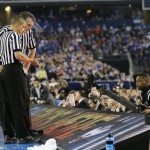 Officials look at a replay during the second half of the NCAA Final Four tournament college basketball championship game between Connecticut and Kentucky Monday, April 7, 2014, in Arlington, Texas. (AP Photo/Eric Gay)