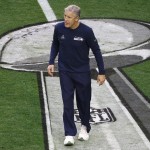 Seattle Seahawks head coach Pete Carroll walks on the field before the NFL Super Bowl XLIX football game against the New England Patriots Sunday, Feb. 1, 2015, in Glendale, Ariz. (AP Photo/Charlie Riedel)